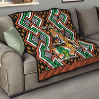 Personalized leopard quilt blanket with bold green, orange, black geometric pattern on sofa