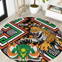 Round black area rug with leopard graphic and green orange geometric African pattern