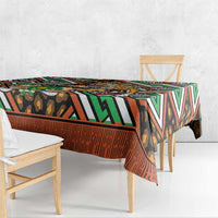 African leopard pattern tablecloth draped over table edge with green, orange, black stripes