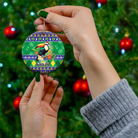 Round ceramic Christmas ornament with toucan motif and Brazil holiday text, held with gold cord