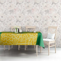 Brazil football tablecloth in yellow with green draped edge across dining table