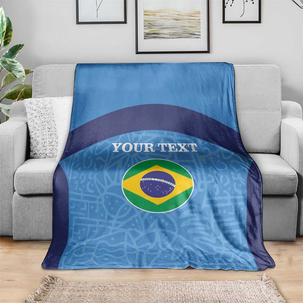 Blue and navy football blanket with Brazil flag circle and custom text on sofa