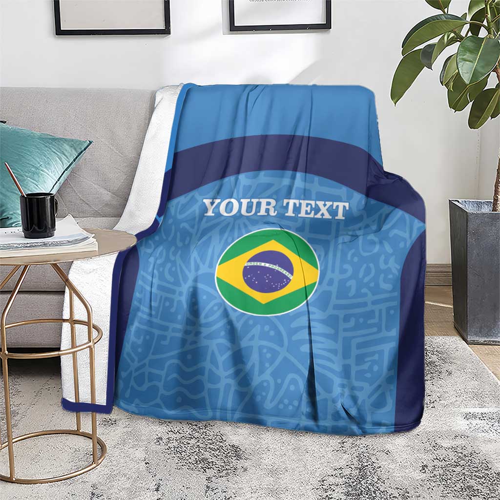 Blue football blanket on grey sofa with Brazil flag circle and custom text