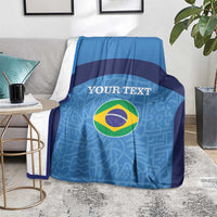 Blue football blanket on grey sofa with Brazil flag circle and custom text