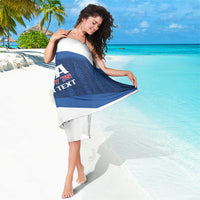 Blue and white diagonal stripe sarong towel with partial USA Rugby 7s text graphic