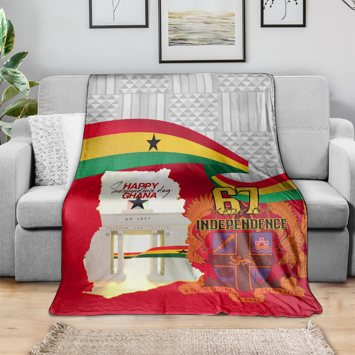 Red Ghana Independence blanket on living room sofa, with Ghana flag arc and “67 Independence”