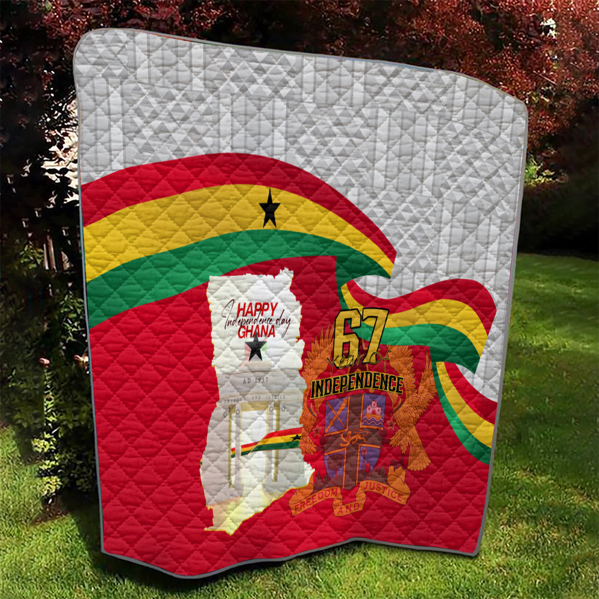 Ghana independence quilt close view on grass, gray white fabric with flag and 67 emblem