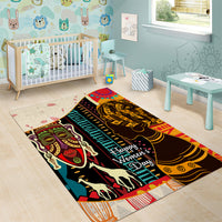 Rectangular African pattern area rug with black and gold profiles, teal and red accents