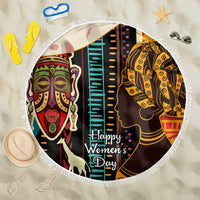 Round beach blanket with fringe, African faces graphic, centered "Happy Women’s Day" print.