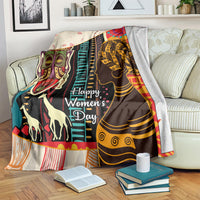 Women’s Day Africa throw blanket draped on a couch with illustrated faces and stripes