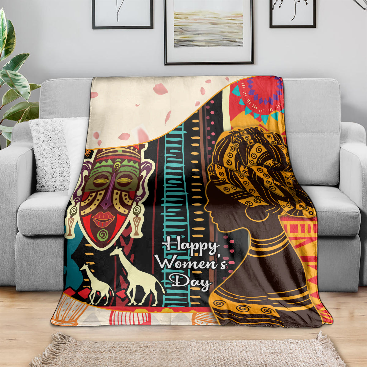 Women’s Day Africa throw blanket on sofa featuring illustrated women faces and colorful stripes