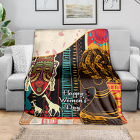 Women’s Day Africa throw blanket on sofa featuring illustrated women faces and colorful stripes