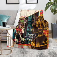 Women’s Day Africa throw blanket on floor with illustrated women portraits and bright stripes