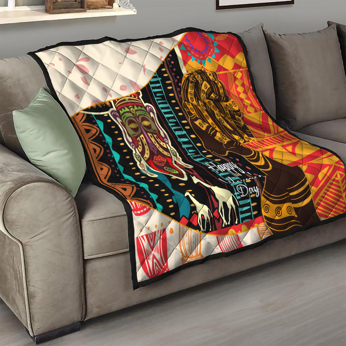 Women's African quilt blanket draped on sofa with bold portraits, multicolor, quilted backing, Happy Women's Day.
