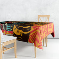 African-inspired tablecloth draped over rectangular table, showing red, yellow, black motifs