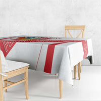 White tablecloth draped on table with red vertical stripe and crest graphics