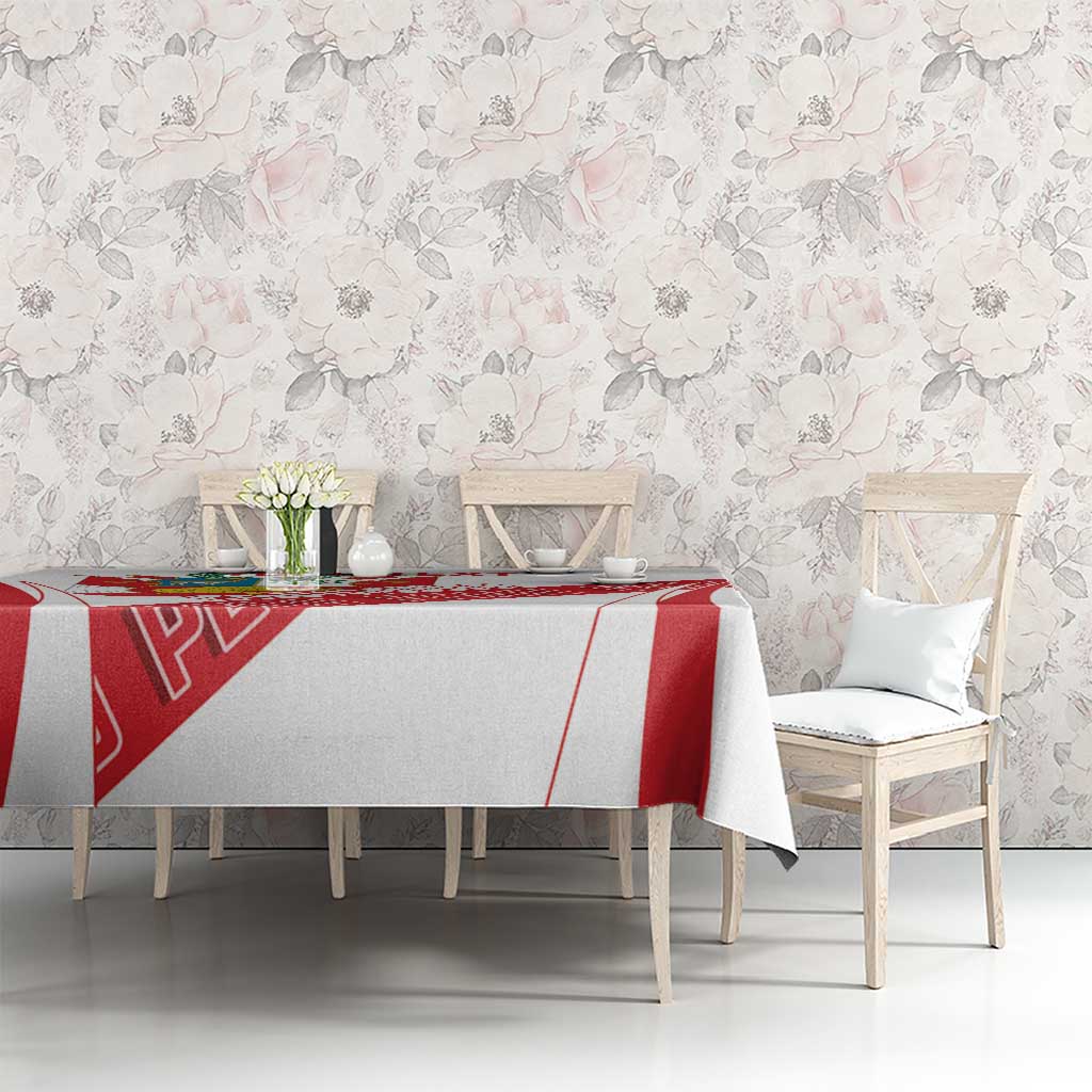 White tablecloth with red stripe and crest print on dining table with chairs