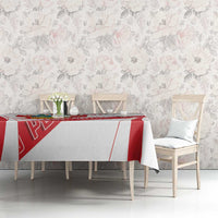 White tablecloth with red stripe and crest print on dining table with chairs