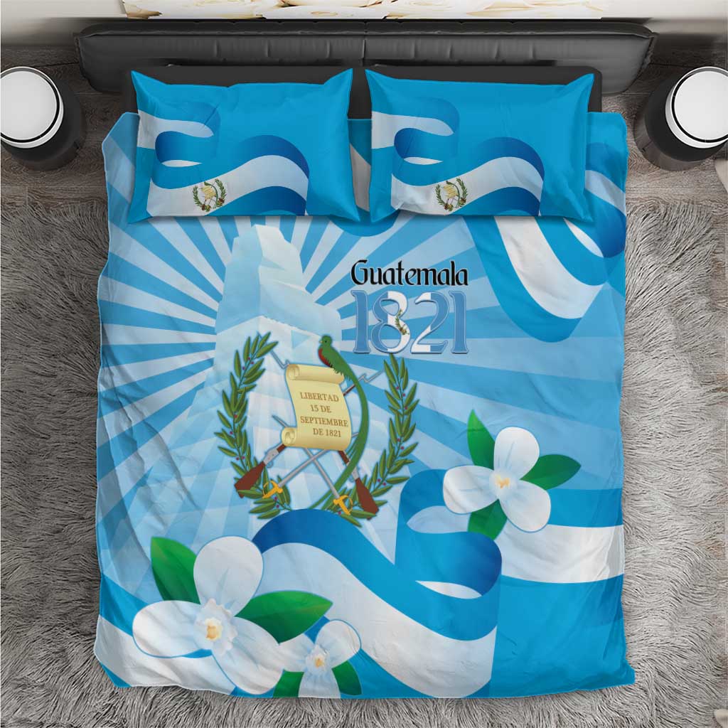 Blue bedding set with Guatemala 1821 crest, floral and flag-style graphic, includes pillow covers.