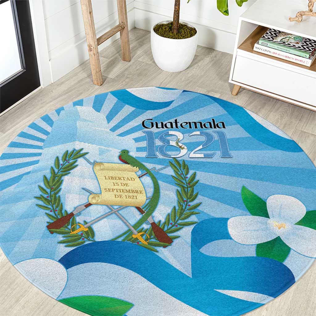 Blue round area rug with Guatemala 1821, coat of arms seal and tropical leaves