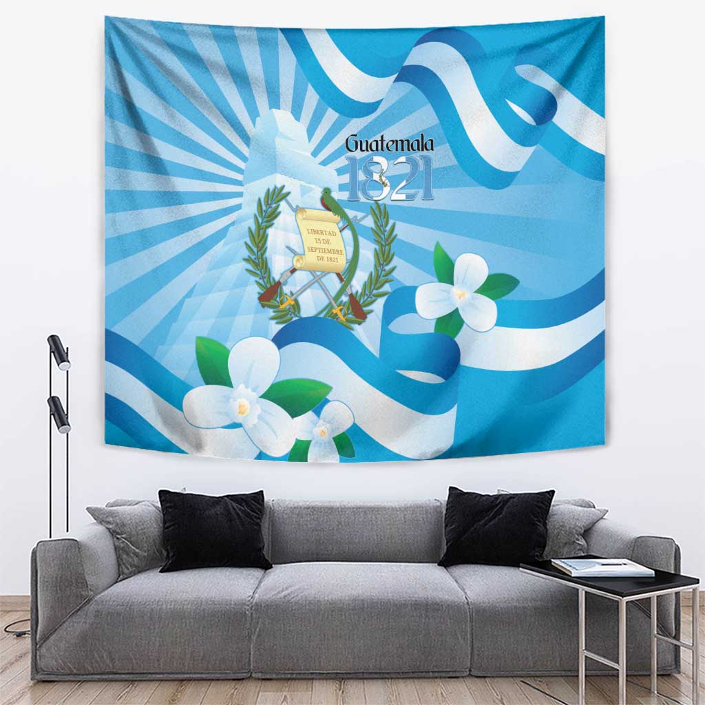 Blue hanging tapestry featuring Guatemala 1821 coat of arms, white blossoms, and light rays