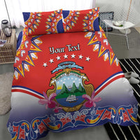 Red duvet cover and two pillow shams with “Your Text” crest, stars, and patterned borders.