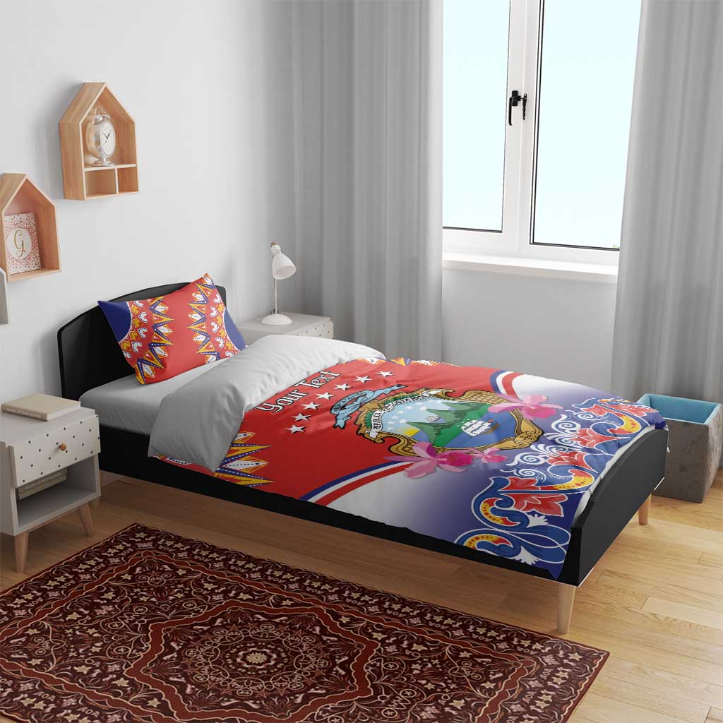 Red, blue and white duvet on bed with crest emblem design and “Your Text” on the front.