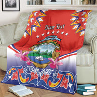 Personalized Costa Rica blanket draped on couch, red top with crest, stars and pink flowers