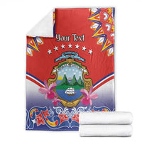 Folded Personalized Costa Rica blanket, red center with crest, stars, blue swirls and pink bows
