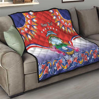 Personalized red quilt draped on gray sofa, Costa Rica crest and blue wave trim