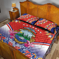 Red quilt bed set with two pillows, 'Your Text' crest, blue floral scroll border