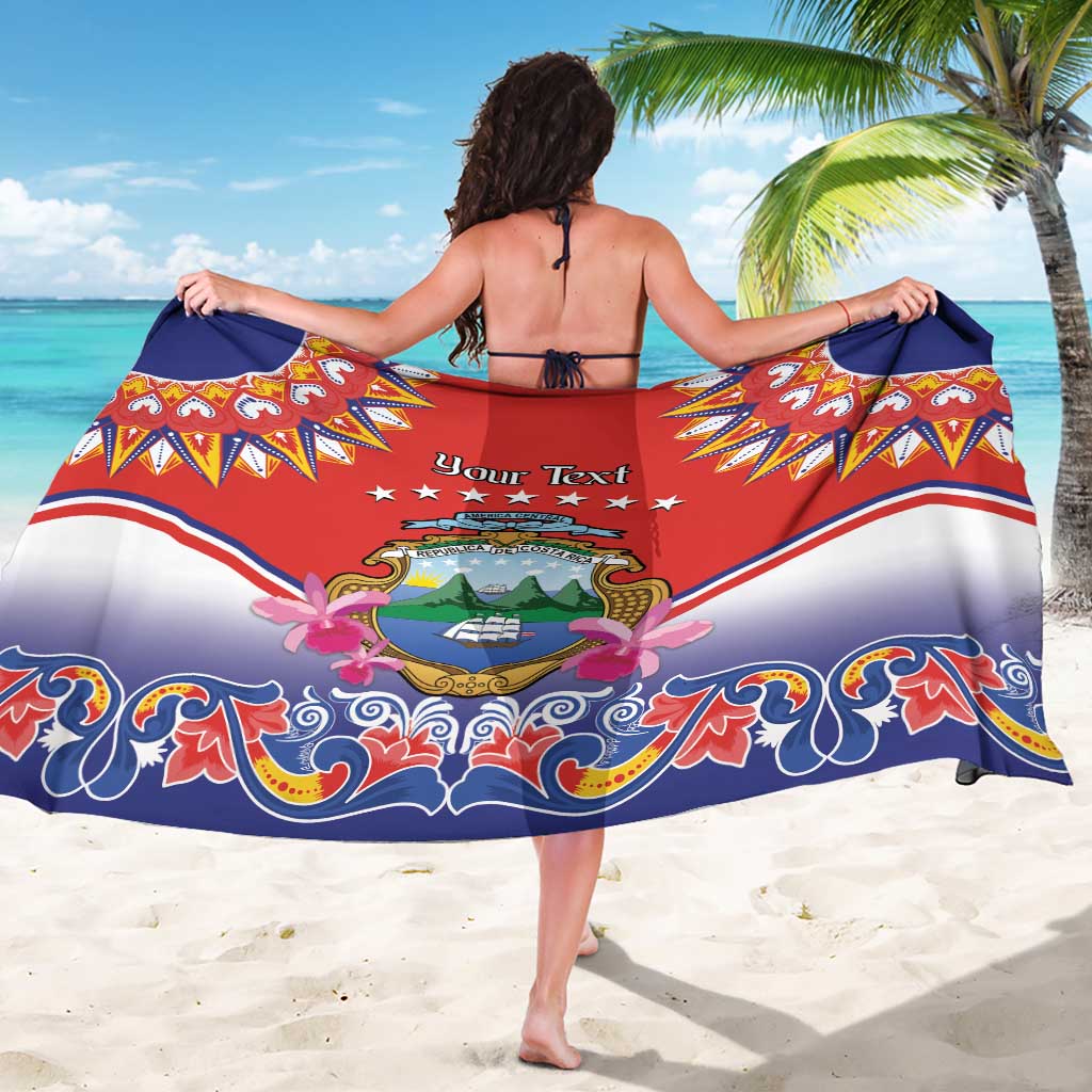 Red folk-pattern sarong with personalized text and Costa Rica crest, large ornate border.