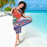 Red and blue folk-pattern sarong with personalized text, floral ribbon motifs, hem border.