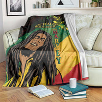 Black throw blanket with reggae-style music notes and portrait graphic, draped on sofa