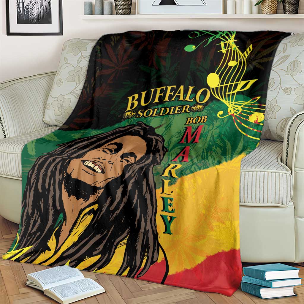 Black, green, and yellow throw blanket with portrait and music-note design, draped on couch