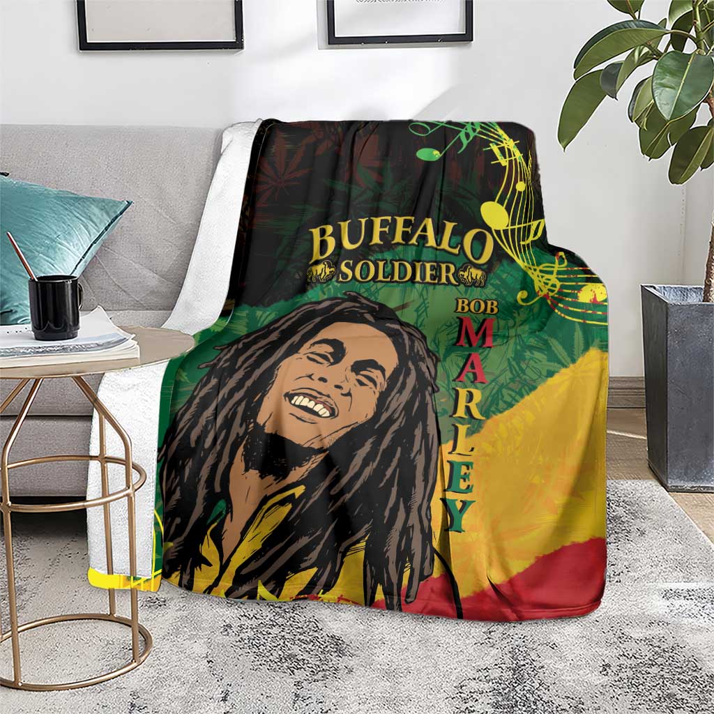 Black throw blanket with portrait artwork and vertical lettering, draped across sofa arm