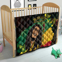 Black quilt blanket on a wooden baby bed, featuring Buffalo Soldier portrait and green/yellow/red blocks.