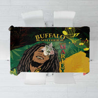Black tablecloth showing “BUFFALO SOLDIER” text, reggae portrait, and musical note accents