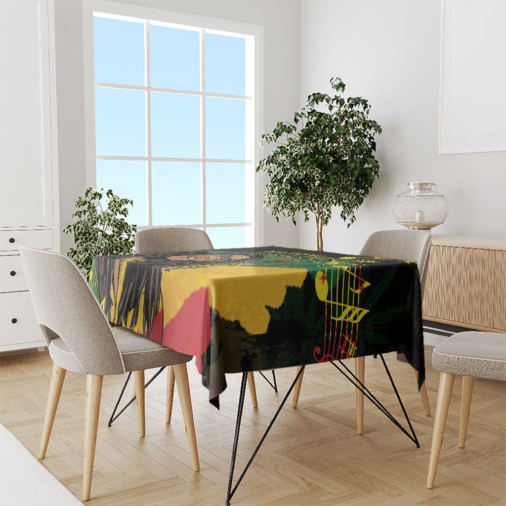 Black tablecloth with colorful reggae-style face and graphic motifs, draped on dining table