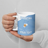 Blue ceramic football mug with Argentina map and 'YOUR TEXT', held by hand