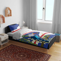 Cape Verde bedding set on bed with blue and red flag bird print, two accent pillows