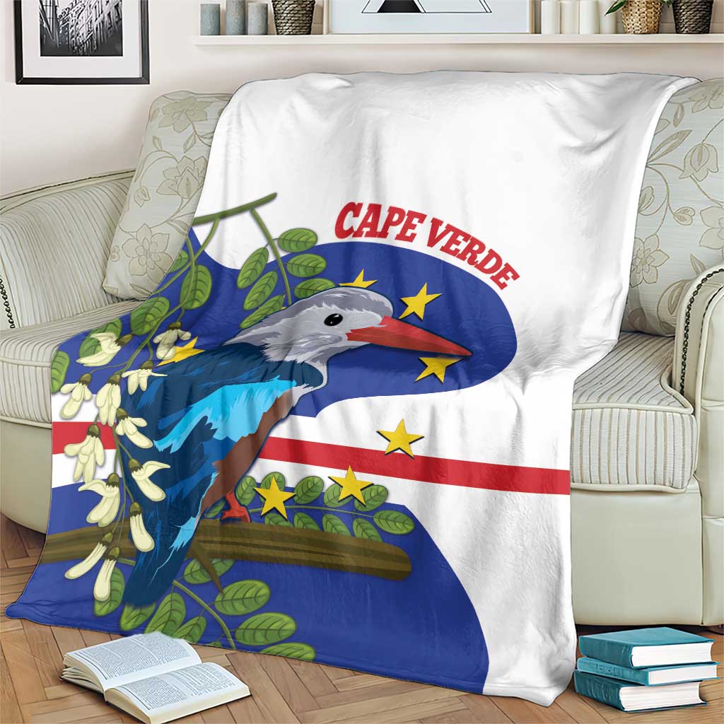White blanket with blue, red, and yellow stripes and bird emblem on a sofa