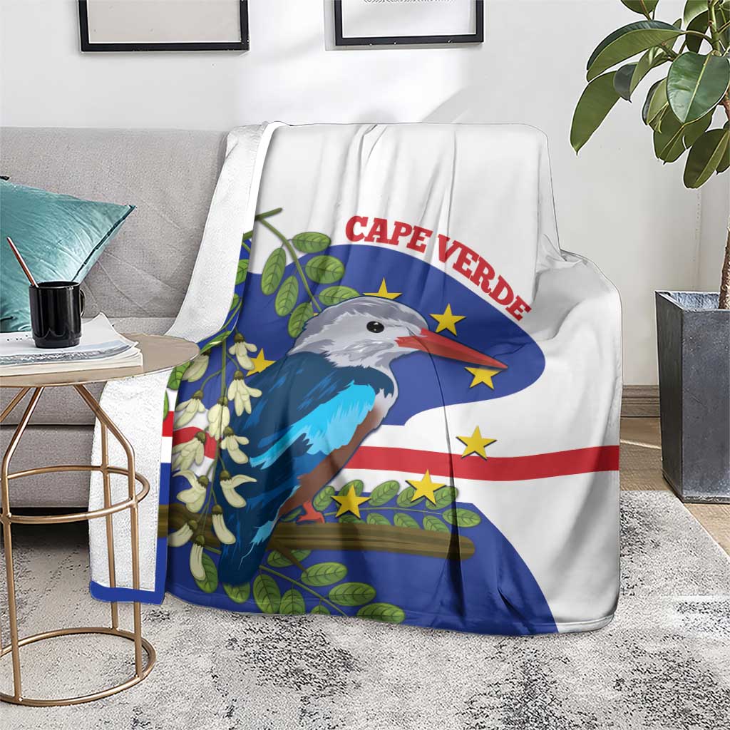 White and blue bird flag throw blanket on a grey chair, graphic centered