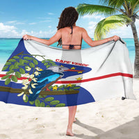 Cape Verde sarong draped over shoulders, bird-and-stars design with blue and red bands