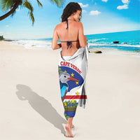 Cape Verde sarong worn as a wrap towel, white fabric with blue bird and star motifs