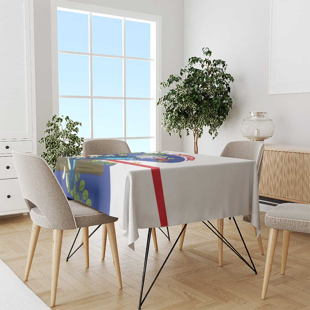 Rectangular tablecloth with blue bird print, red and green accents on dining table