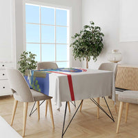 Rectangular tablecloth with blue bird print, red and green accents on dining table