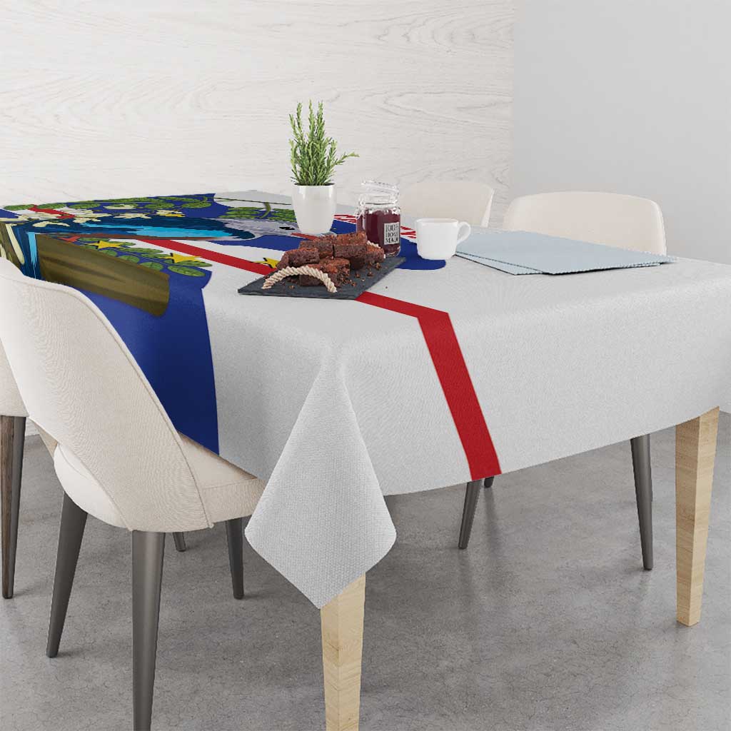 Blue, white, and red tablecloth draped on dining table with bird and leaf print