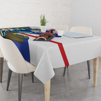 Blue, white, and red tablecloth draped on dining table with bird and leaf print