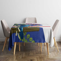 Small rectangular tablecloth with blue bird and leaf print and red stripe on table